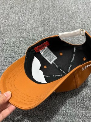 Honey-colored Hermes embroidered circular “H” logo baseball cap