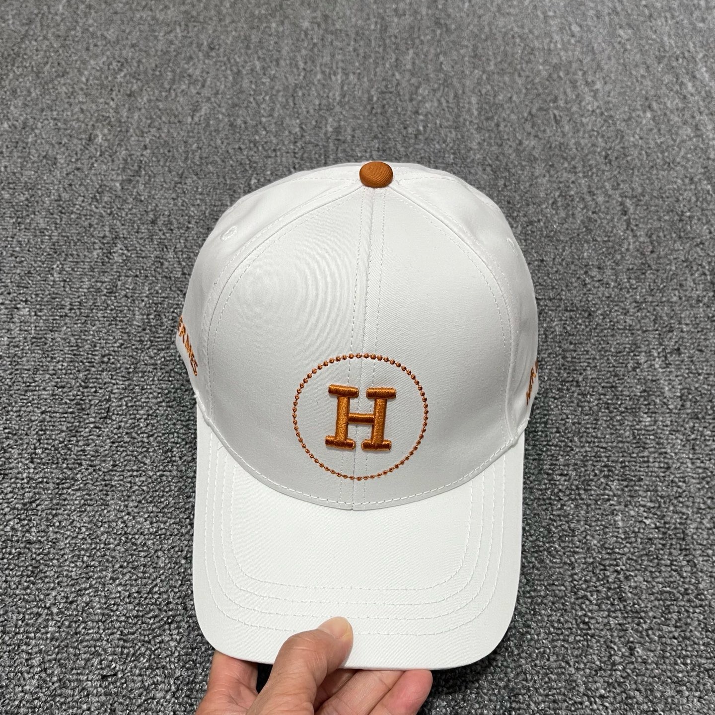 White Hermes embroidered circular "H" logo baseball cap